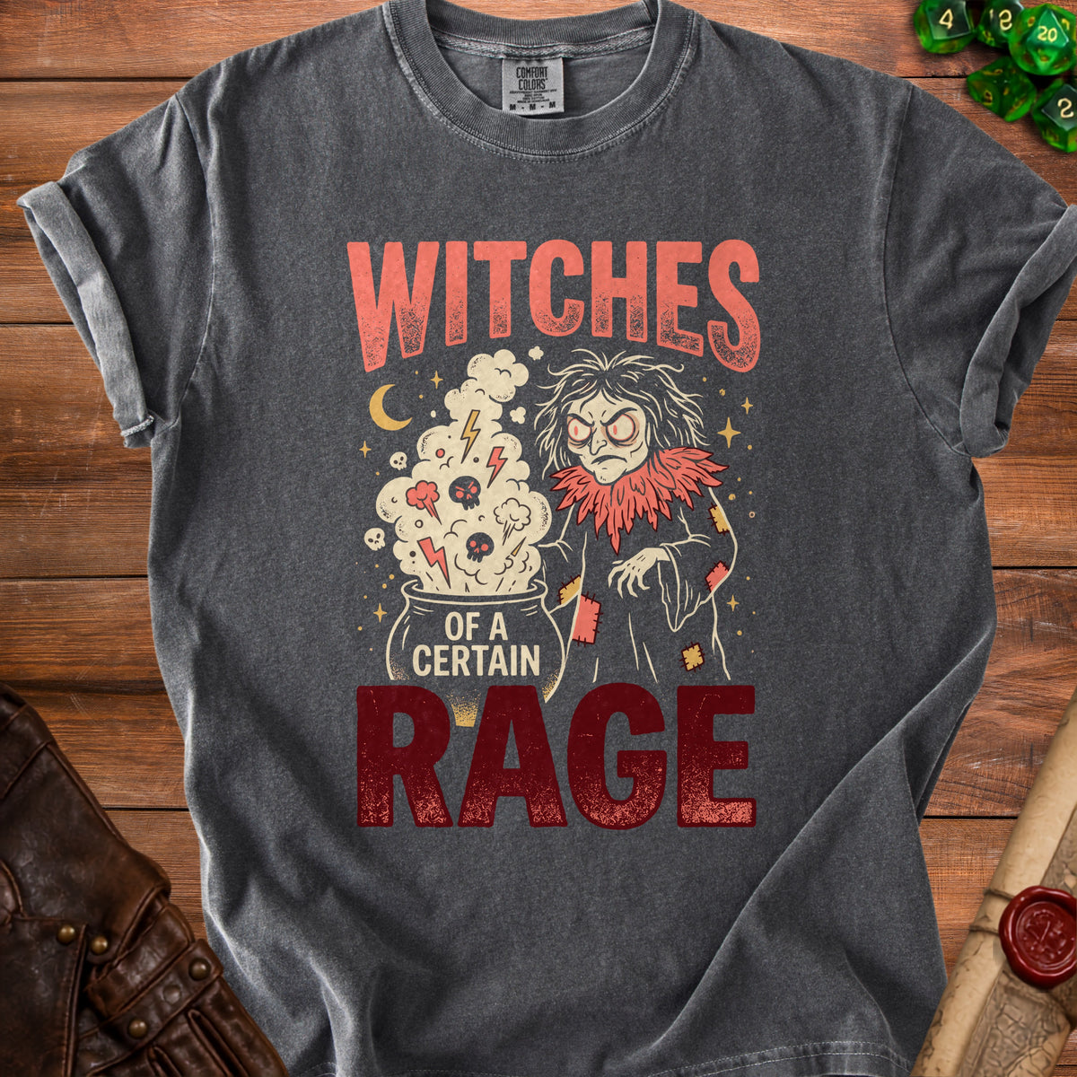 Gray t-shirt with a witch stirring a cauldron, text reads "WITCHES OF A CERTAIN RAGE".
