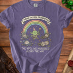 Purple t-shirt with a cartoon image of a creature and fallen adventurers, featuring text.