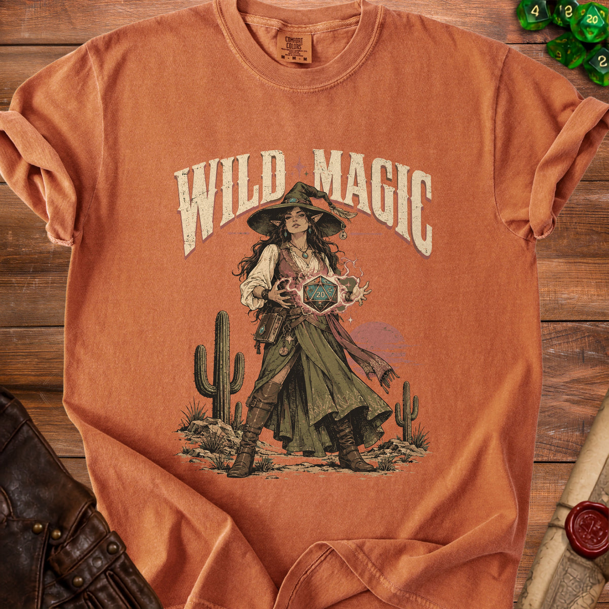 T-shirt with "Wild Magic" text and a fantasy witch holding a twenty-sided die.