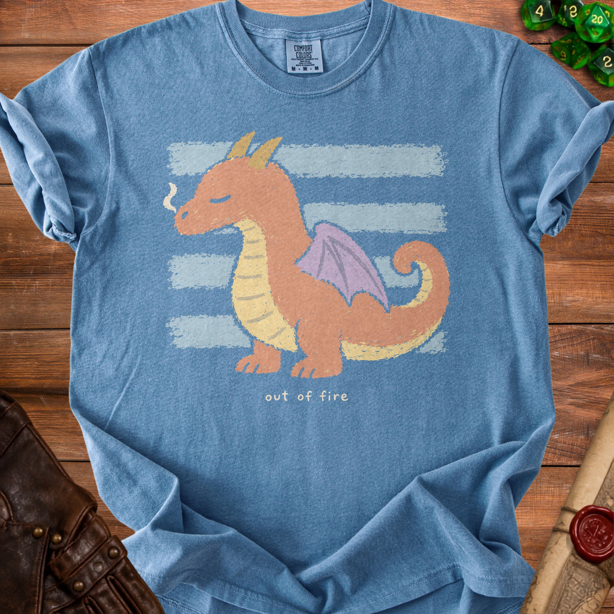 Blue t-shirt with a cartoon dragon and text "out of fire"