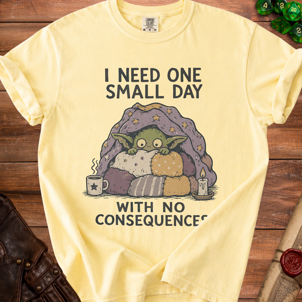 Yellow t-shirt with illustration of creature saying "I need one small day with no consequences."