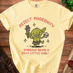 Yellow t-shirt with a goblin graphic and text: "Reject Modernity Embrace Being A Silly Little Goblin".