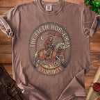 Brown t-shirt with graphic of skeleton grim reaper on horseback, "The Fifth Horseman Stupidity".