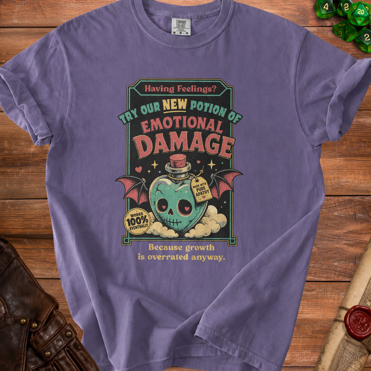 Purple t-shirt with "Emotional Damage" potion graphic and quote "Because growth is overrated anyway."