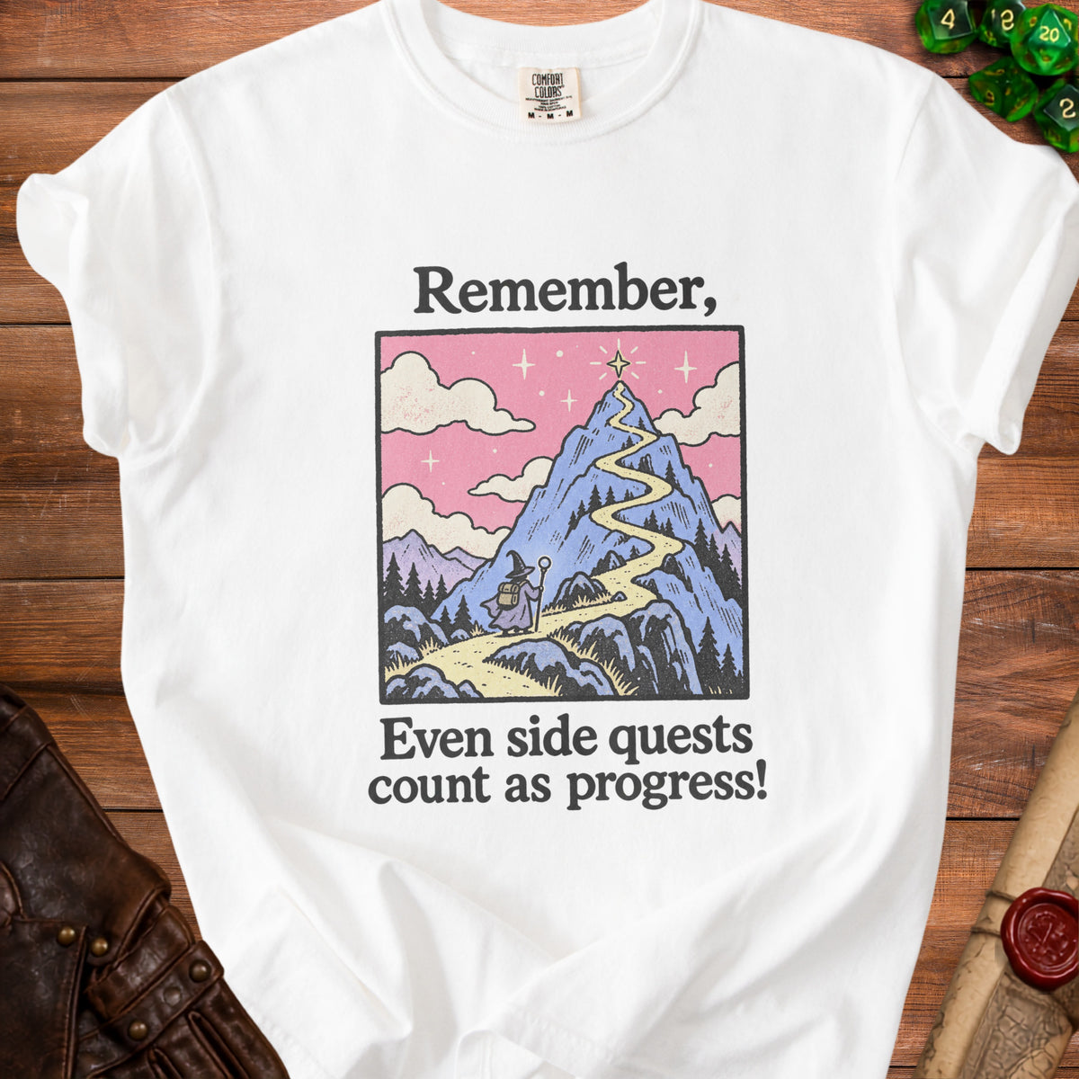 White t-shirt graphic: wizard on mountain path, text "Remember, Even side quests count as progress!"