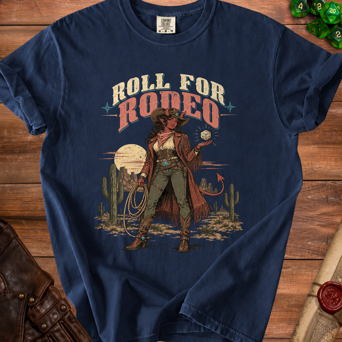 T-shirt with "Roll for Rodeo" text and a devilish cowgirl in a desert landscape.