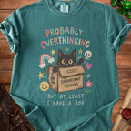 Teal t-shirt with a black cat in a box, text "PROBABLY OVERTHINKING BUT AT LEAST I HAVE A BOX".