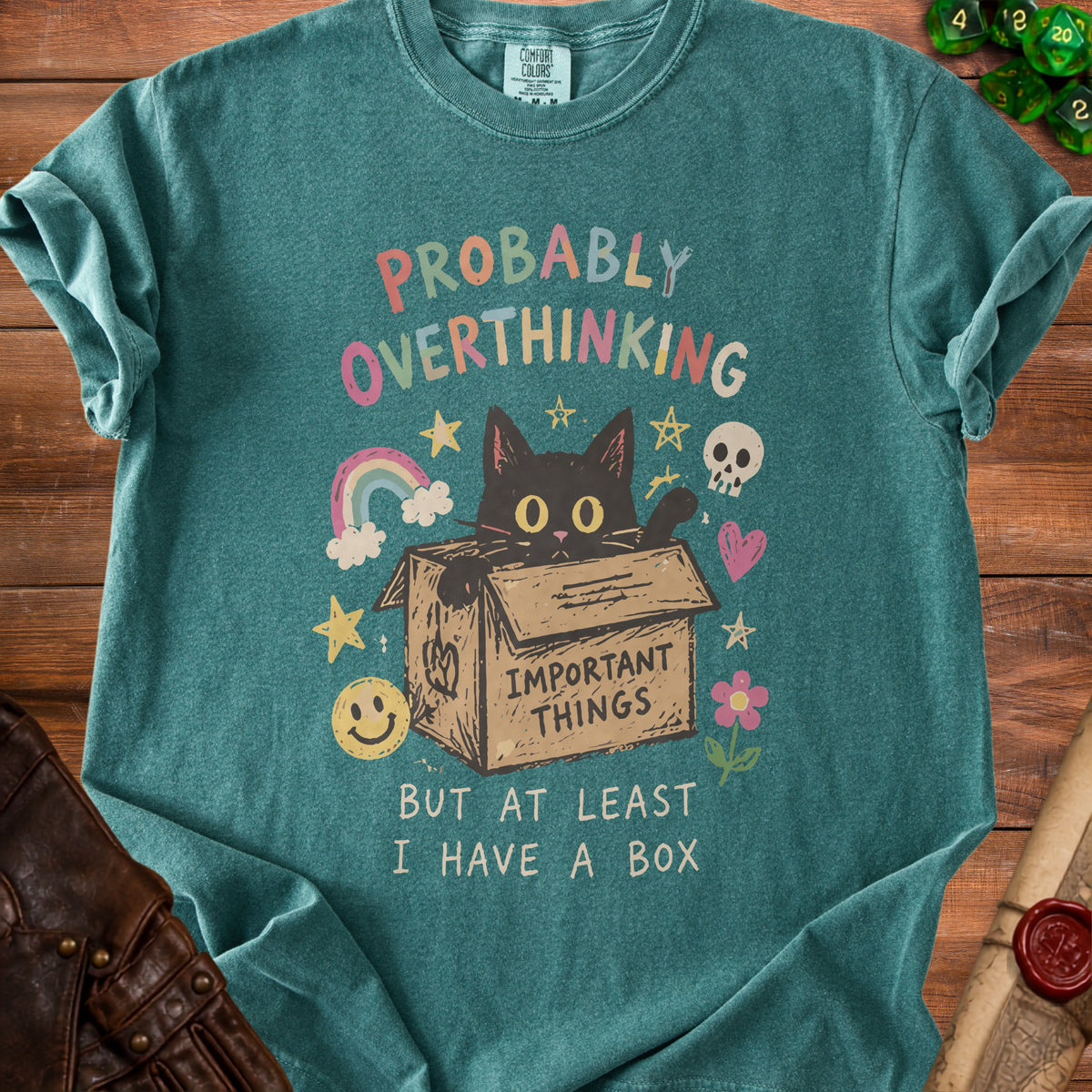 Teal t-shirt with a black cat in a box, text "PROBABLY OVERTHINKING BUT AT LEAST I HAVE A BOX".