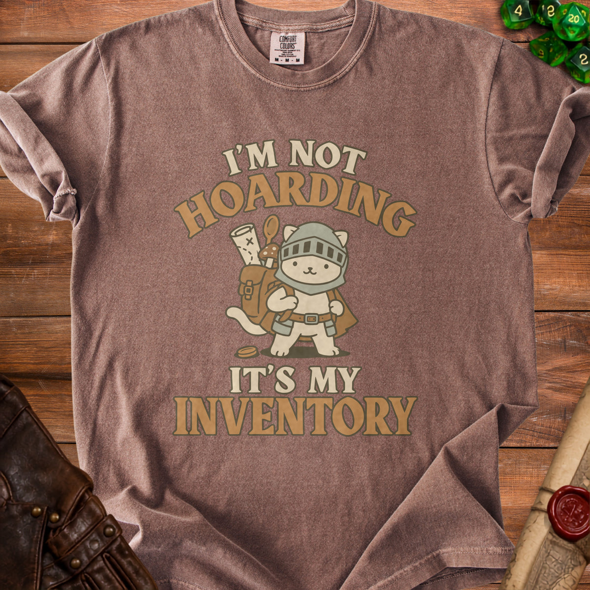 Brown t-shirt with a cartoon cat knight graphic and text "I'M NOT HOARDING IT'S MY INVENTORY".