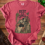Skeleton with cat and mug, "Rest is a Spell" text.