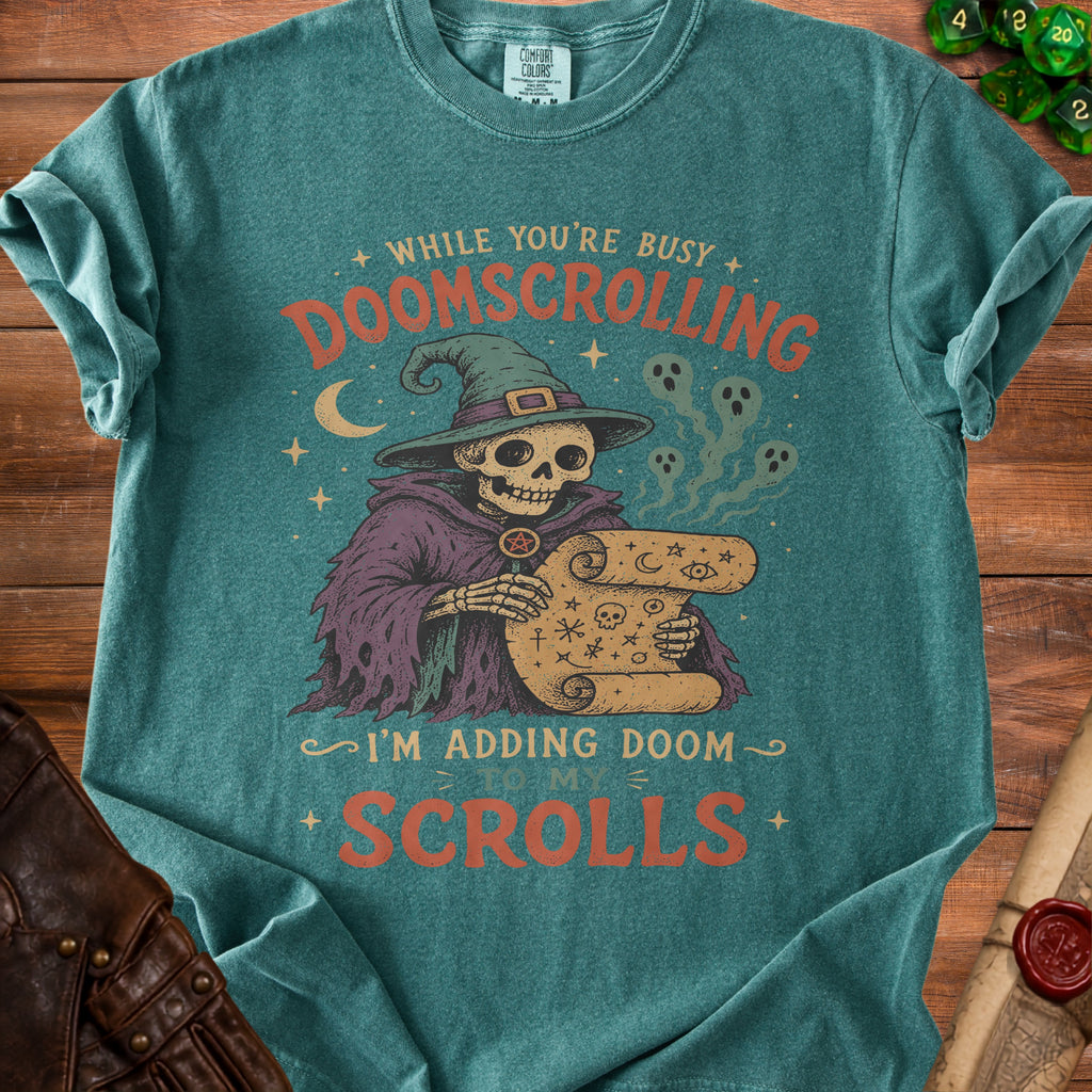 Skeleton witch with scroll, "While You're Busy Doomscrolling, I'm Adding Doom to My Scrolls."