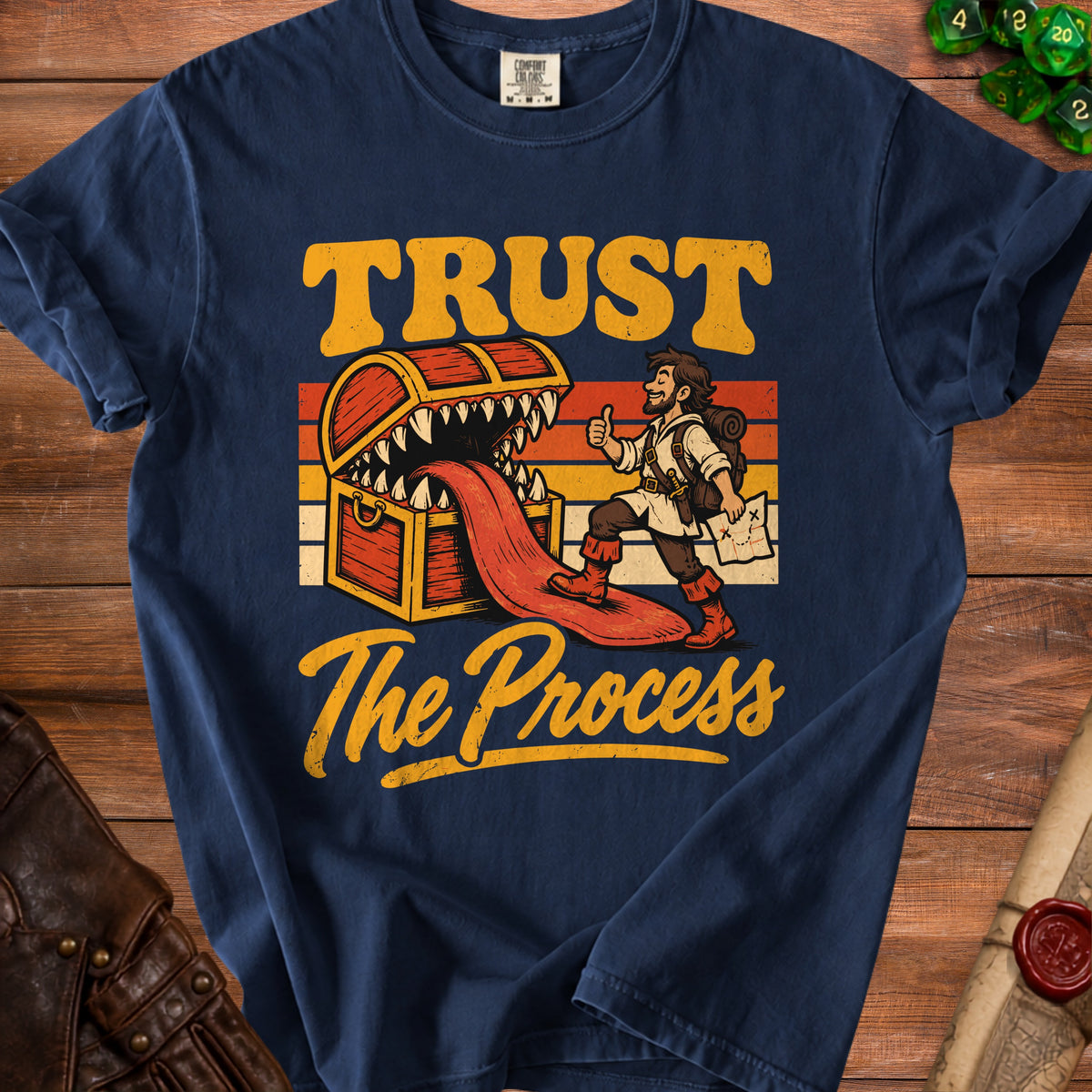 T-shirt with text "TRUST The Process" and a drawing of a treasure chest.