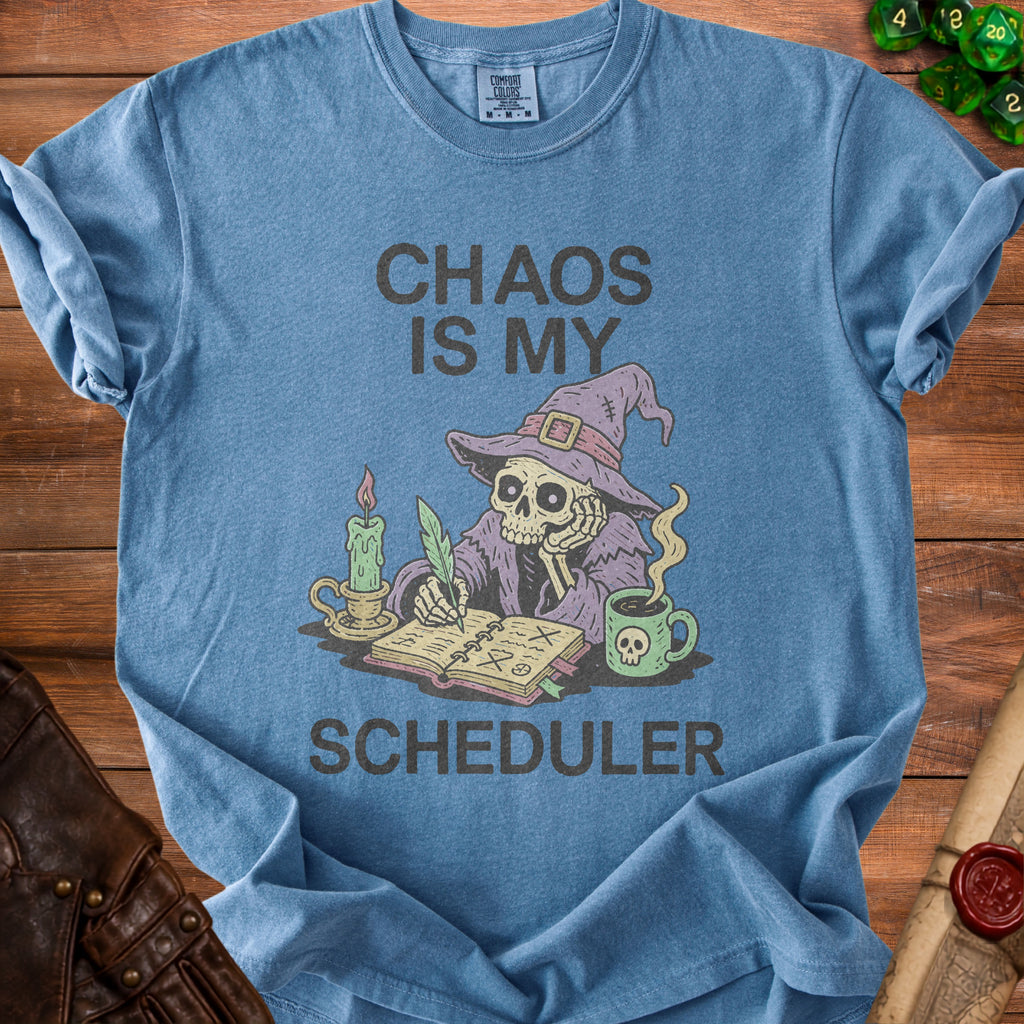 Blue t-shirt with skeleton wizard writing "Chaos Is My Scheduler" and a skull mug.