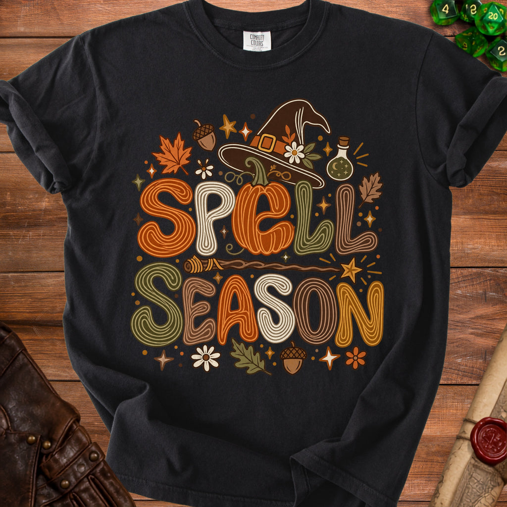 Black t-shirt with "Spell Season" text and Halloween motifs.