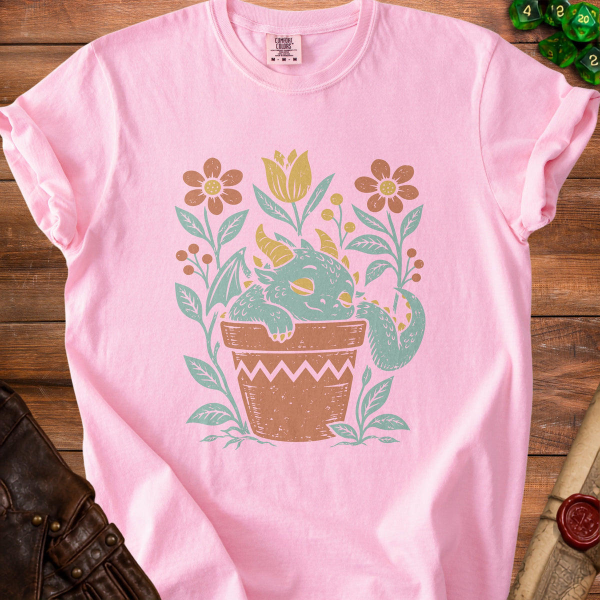 Pink t-shirt with a cute dragon in a flower pot graphic.