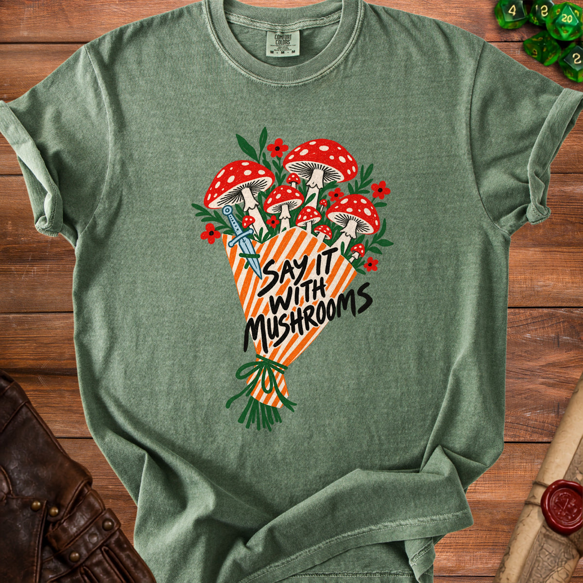 Green t-shirt with a bouquet of mushrooms, dagger, and text "Say It With Mushrooms".