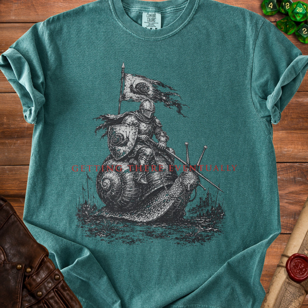 Knight on snail with flag and swords, "Getting There Eventually" text on shirt.