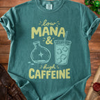 Teal t-shirt with "Low Mana & High Caffeine" graphic featuring a flask and iced coffee.