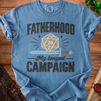 Blue t-shirt with "FATHERHOOD My longest CAMPAIGN" and a twenty-sided die.