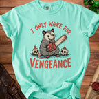 Aqua t-shirt with possum holding chainsaw and text "I ONLY WAKE FOR VENGEANCE".