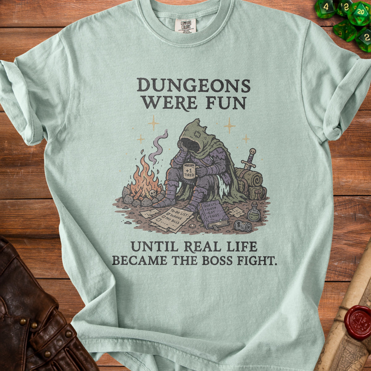 Light blue t-shirt with "Dungeons Were Fun Until Real Life Became The Boss Fight."