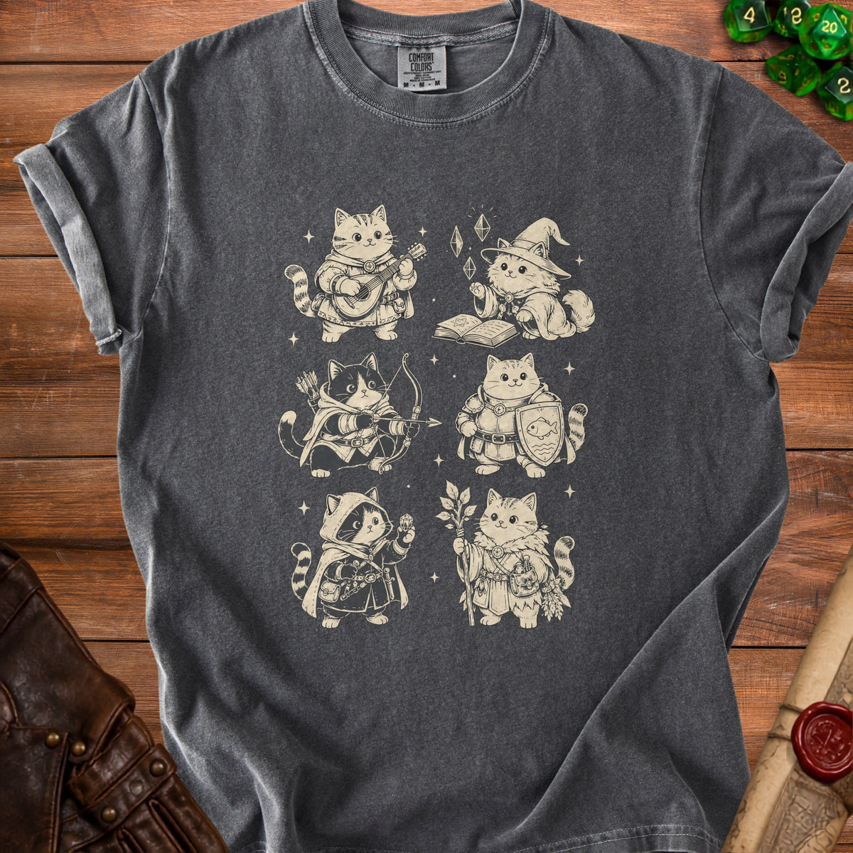 A dark gray t-shirt with a vintage-style graphic of six fantasy cats dressed as RPG classes.