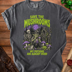 Dark grey t-shirt with "Save the Mushrooms" and "My Potions Are Already Weird" text and spooky illustration.