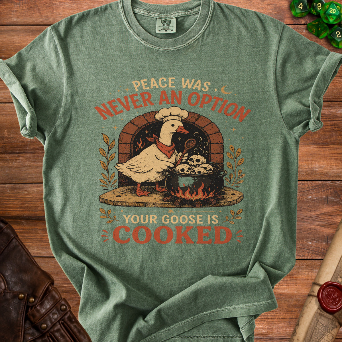Green t-shirt with "Peace was never an option, your goose is cooked" text and goose graphic.