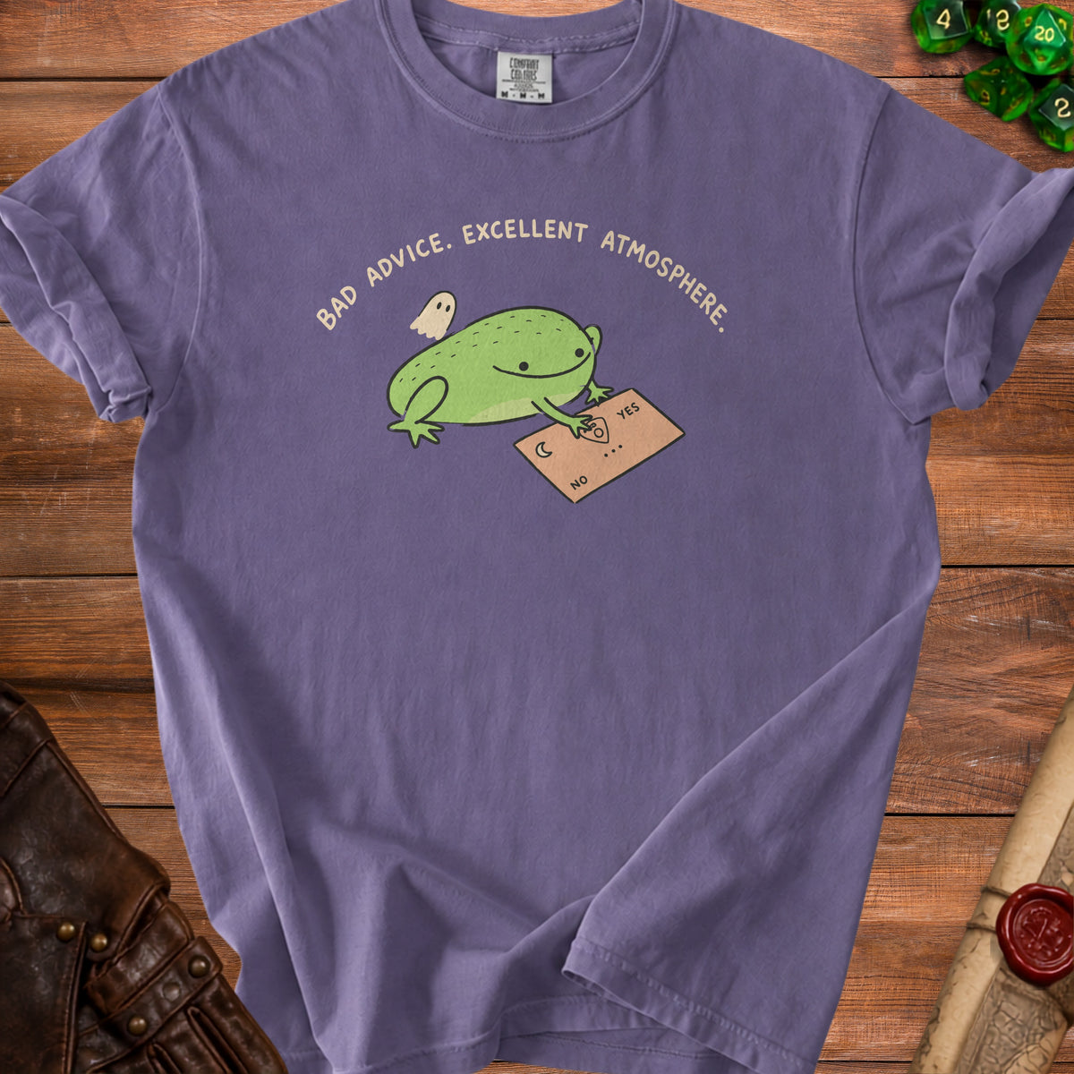 Purple t-shirt with graphic of frog and ghost using a Ouija board that reads "BAD ADVICE. EXCELLENT ATMOSPHERE."