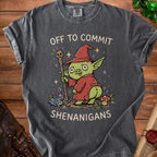 T-shirt with a green wizard character and text "Off to commit shenanigans".