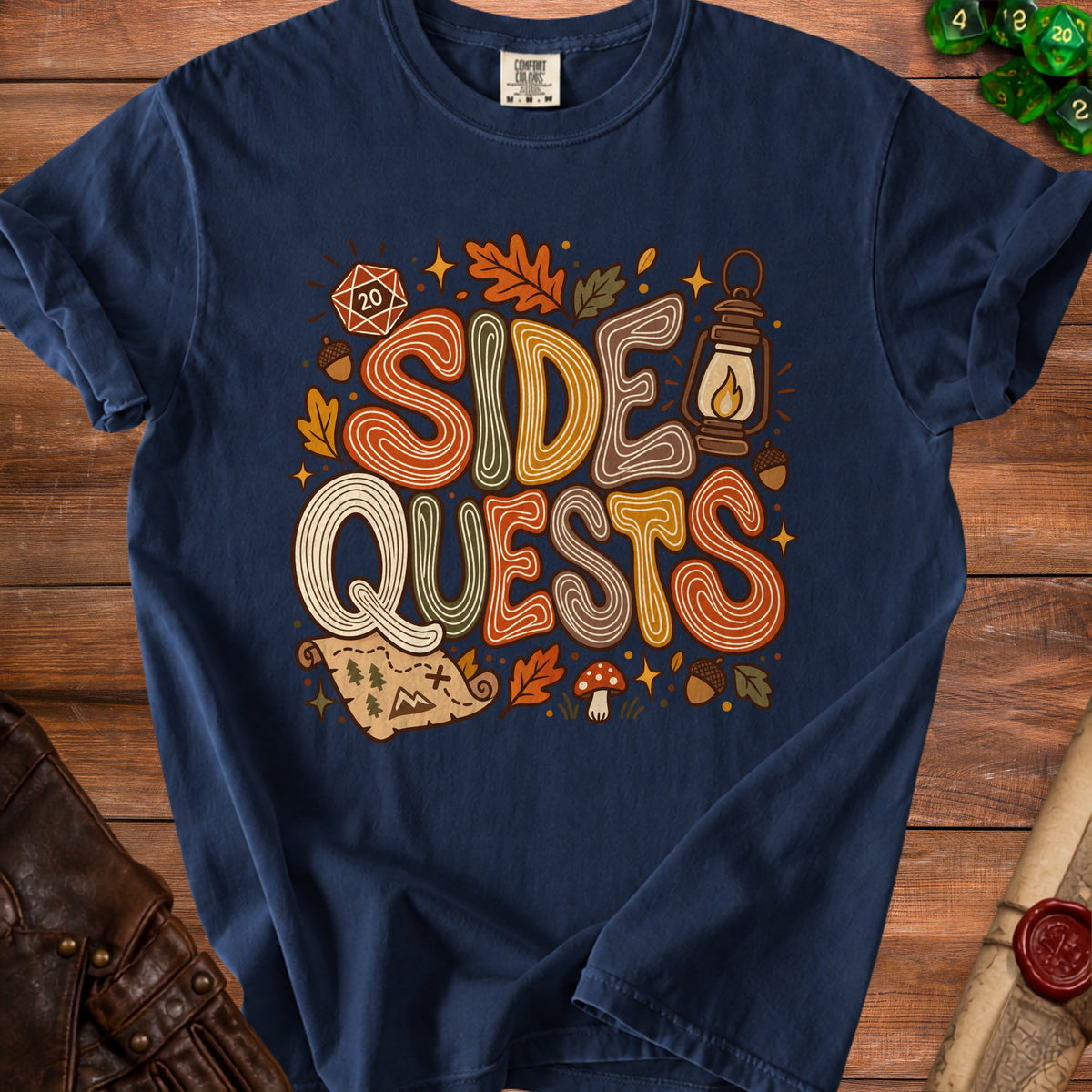 Navy t-shirt with "SIDE QUESTS" text and D20, map, and autumn motifs.