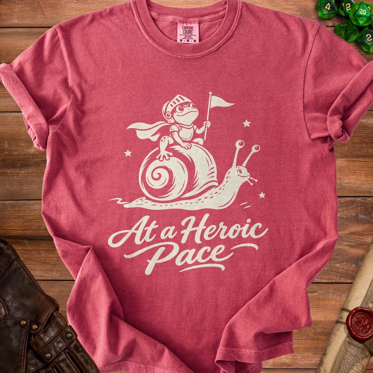 Red t-shirt with a graphic of a knight frog riding a snail with text "At a Heroic Pace".