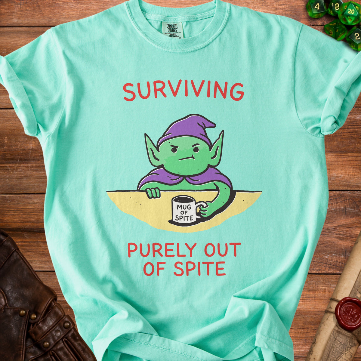 Mint green t-shirt with a grumpy gnome holding a "Mug of Spite".