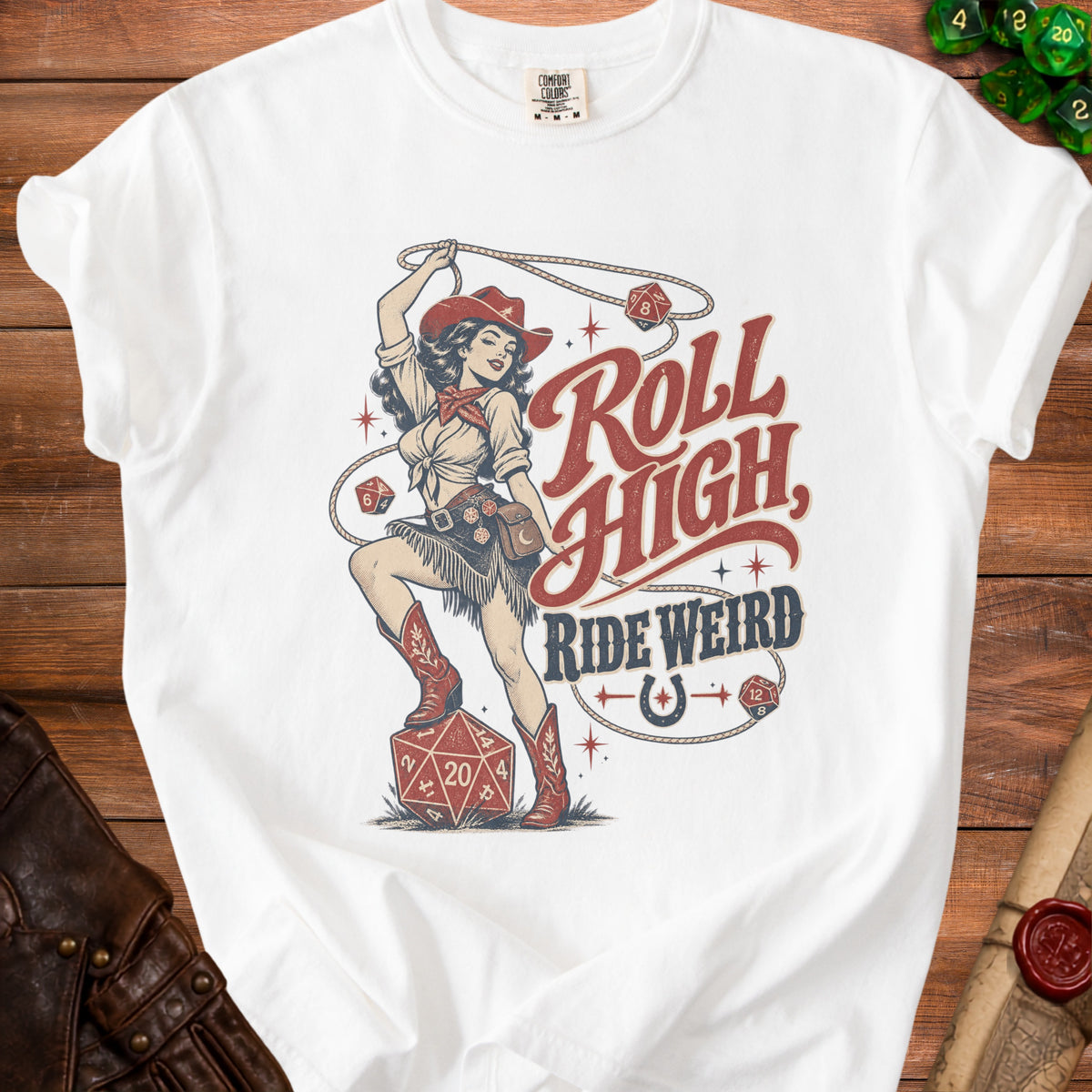 White t-shirt with cowgirl, lasso, dice, and text "Roll High, Ride Weird".