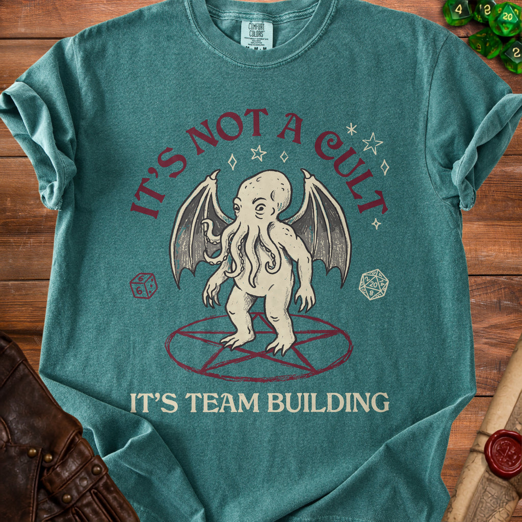 T-shirt with Cthulhu illustration and text "IT'S NOT A CULT IT'S TEAM BUILDING".