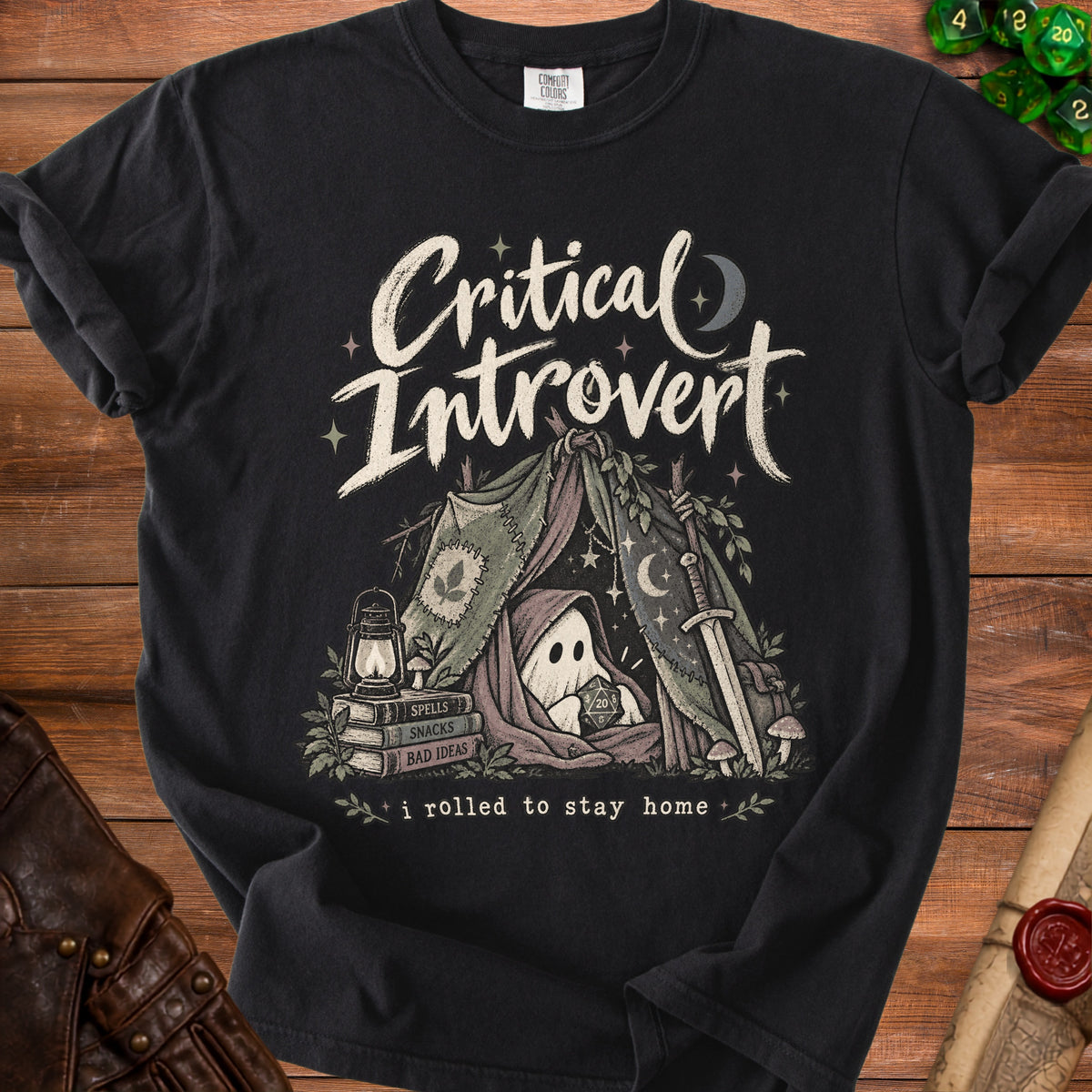 Black t-shirt with "Critical Introvert" text, a ghost holding a D20, and "I rolled to stay home" slogan.