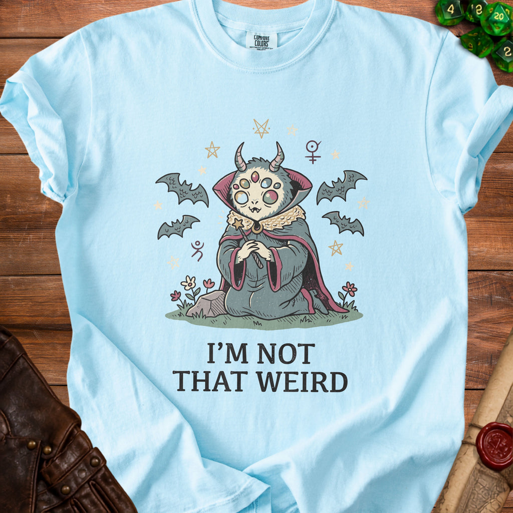 Light blue t-shirt with a creature with multiple eyes and horns and bats.