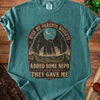 Teal t-shirt with Mothman graphic and text "Wish my parents would've added some nepo to the tism they gave me."