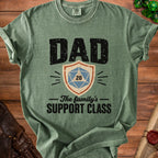 Green t-shirt with "DAD THE FAMILY'S SUPPORT CLASS" and D20 dice graphic.
