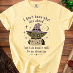 Yellow t-shirt with graphic of a goblin in a wizard hat holding a map.