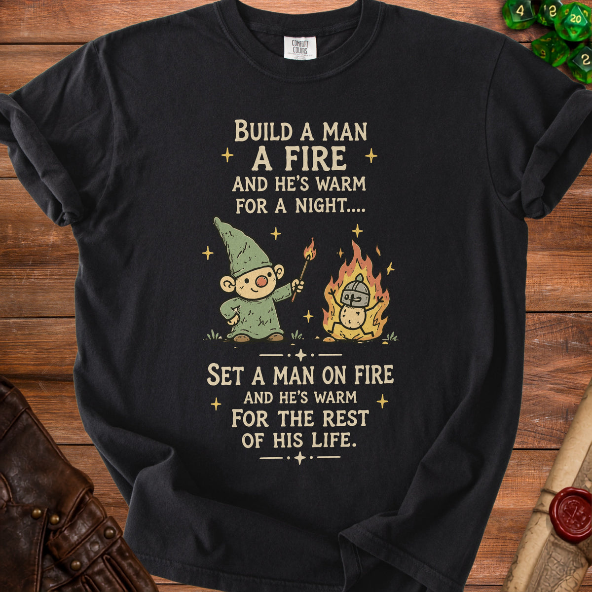Black t-shirt with gnome, fire, and text "Build a man a fire... Set a man on fire...".