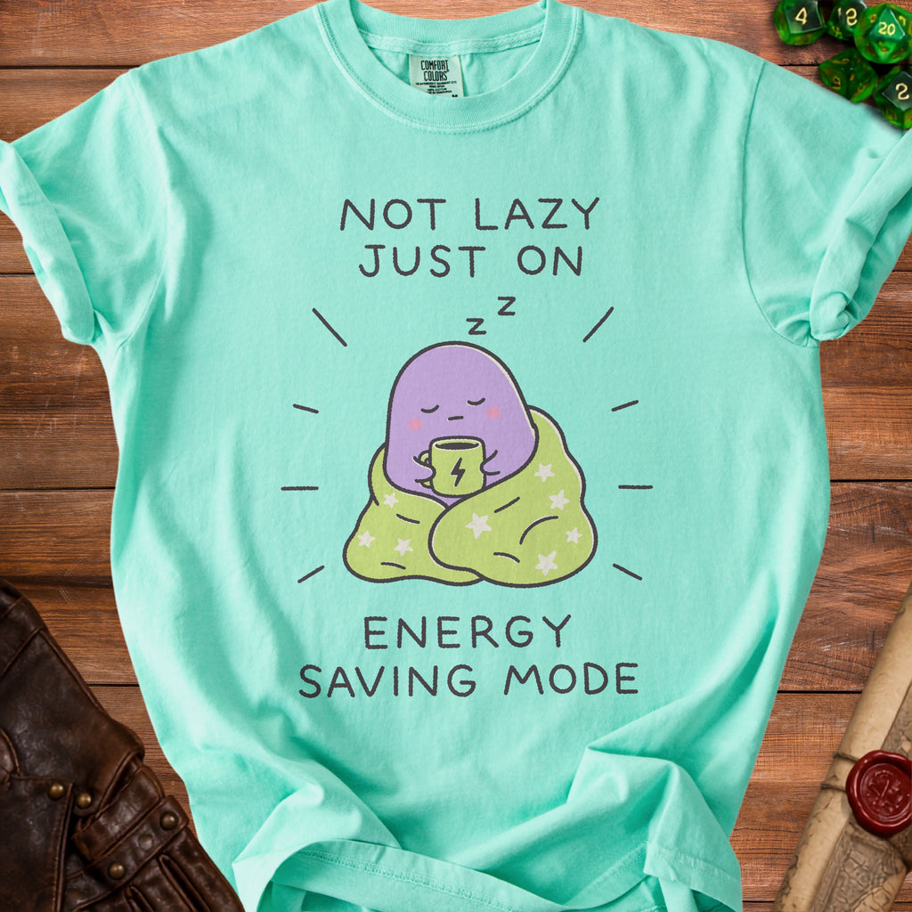 Teal t-shirt with graphic of purple blob drinking from mug, "NOT LAZY JUST ON ENERGY SAVING MODE".