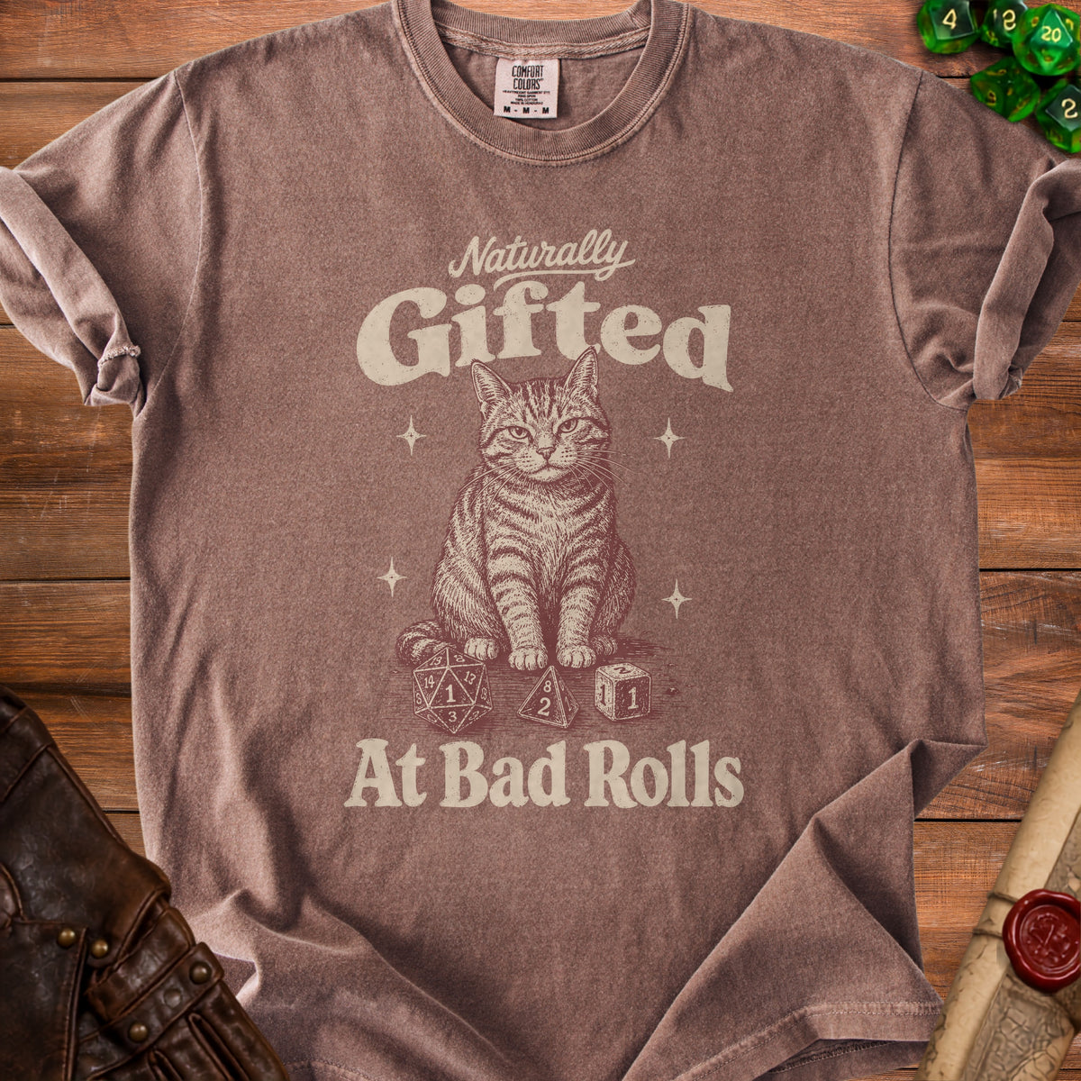 Brown t-shirt with a cat illustration and text "Naturally Gifted At Bad Rolls".
