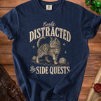 Navy t-shirt with a tabby cat, dice, and text "Easily Distracted By SIDE QUESTS."