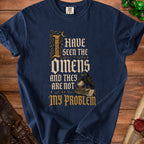 Navy t-shirt with "I have seen the omens and they are not my problem" text.