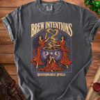 Dark gray t-shirt with "Brew Intentions Questionable Spells" text and witchy graphic.
