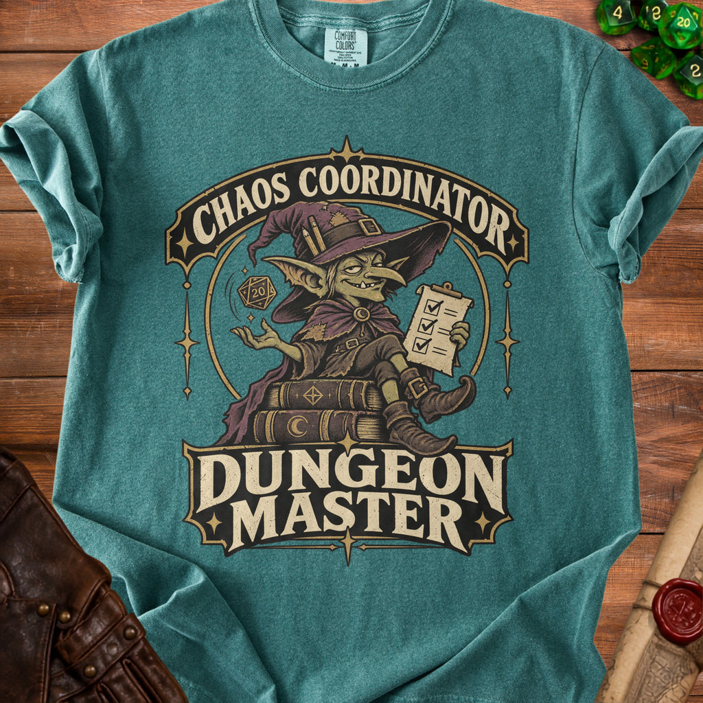 Teal t-shirt featuring a graphic of a goblin wizard sitting on books, with the text Chaos Coordinator and Dungeon Master.