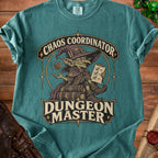 Teal t-shirt featuring a graphic of a goblin wizard sitting on books, with the text Chaos Coordinator and Dungeon Master.