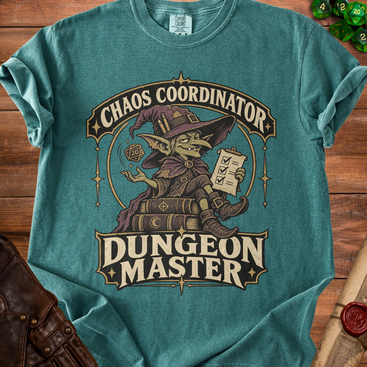 Teal t-shirt featuring a graphic of a goblin wizard sitting on books, with the text Chaos Coordinator and Dungeon Master.