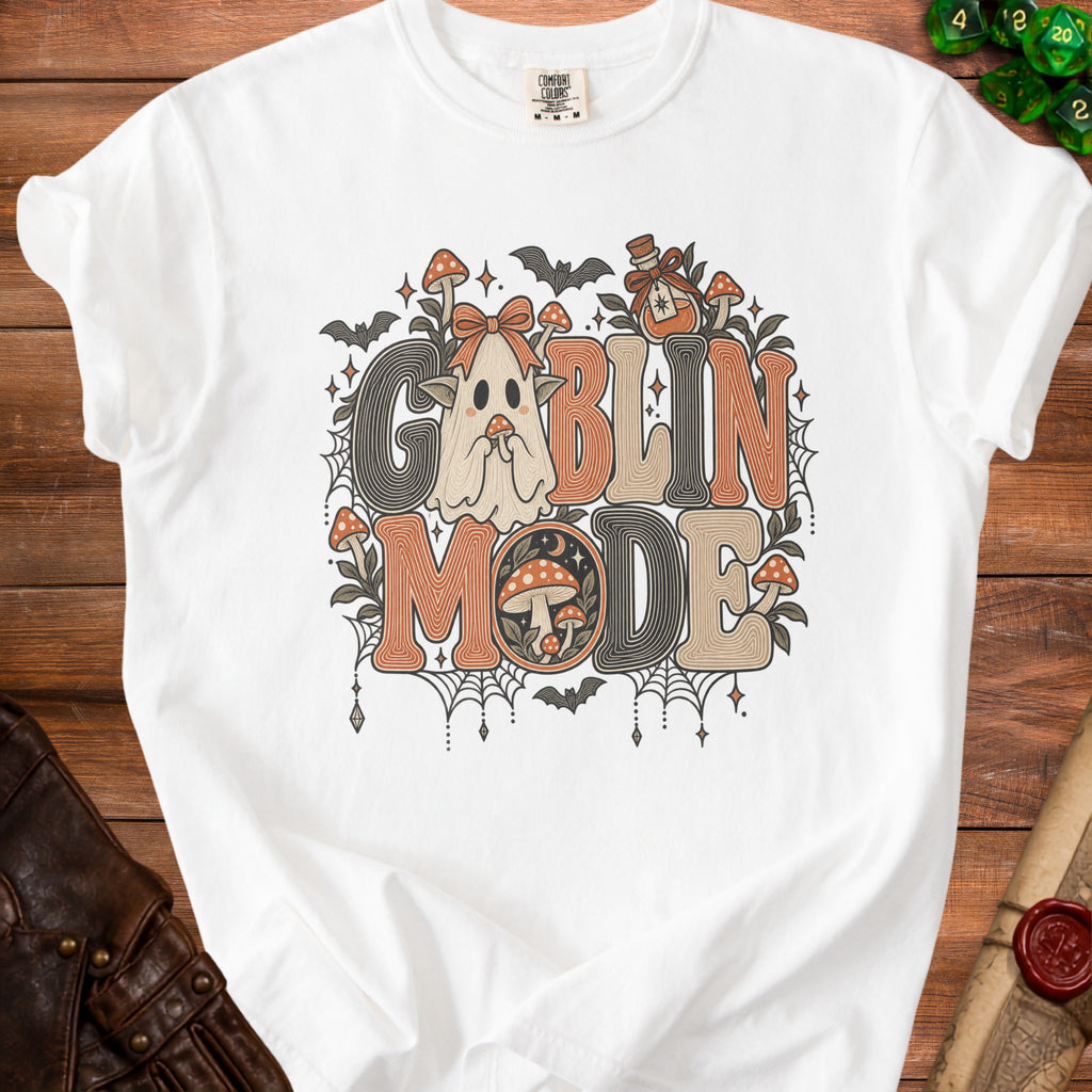 White t-shirt with "Goblin Mode" text featuring a ghost, mushrooms, bats, and potion.